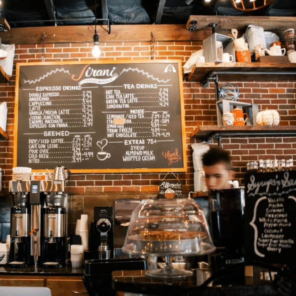 A barista behind the counter in a trendy coffee shop